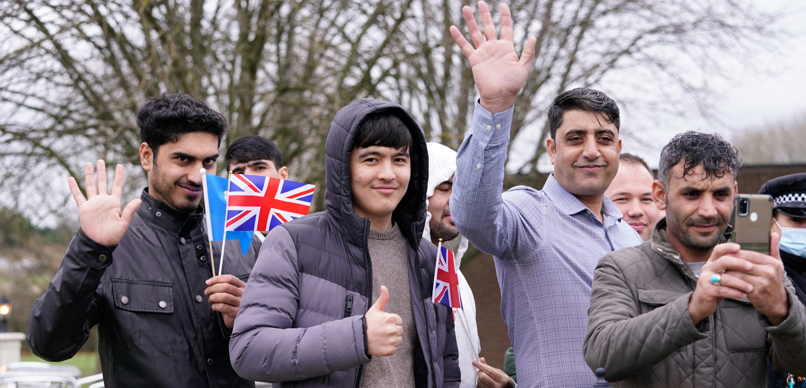 Sunder Katwala: Two years on from the fall of Kabul. LEEDS, ENGLAND - NOVEMBER 30 2021: Refugees wave as the Duke of Cambridge leaves after a visit to a local hotel in Leeds, which is being used to accommodate refugees evacuated from Afghanistan on November 30, 2021 in Leeds, England. (Photo by  Danny Lawson - WPA Pool/Getty Images)