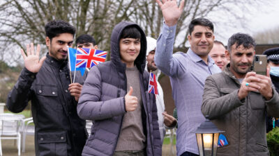 Sunder Katwala: Two years on from the fall of Kabul. LEEDS, ENGLAND - NOVEMBER 30 2021: Refugees wave as the Duke of Cambridge leaves after a visit to a local hotel in Leeds, which is being used to accommodate refugees evacuated from Afghanistan on November 30, 2021 in Leeds, England. (Photo by Danny Lawson - WPA Pool/Getty Images)