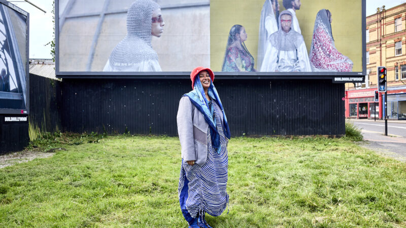 Artist Asmaa Jana stands in front of their All About Love commission by BUILDHOLLYWOOD, 2023.