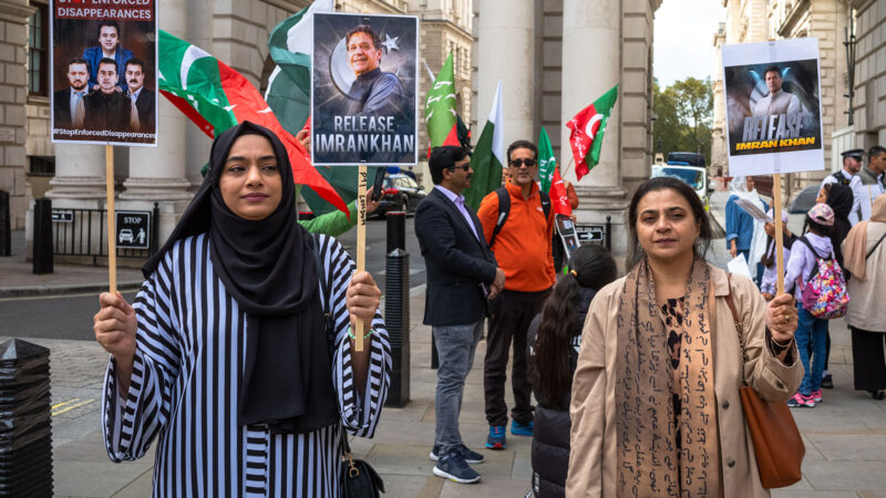 Two Pakistani women protest in London against Imran Khan's jail sentencing in Pakistan.