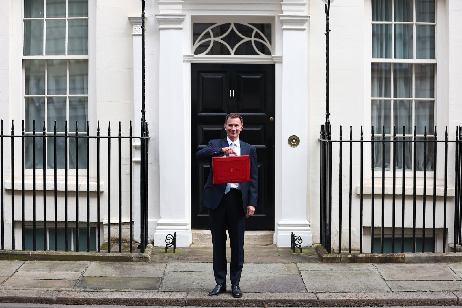 Chancellor of the Exchequer Jeremy Hunt poses with a red briefcase outside 10, Downing Street. 