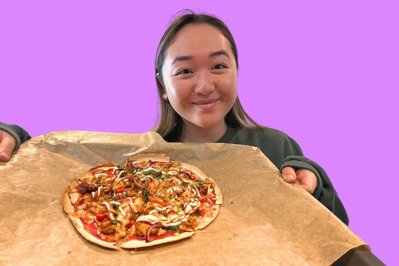 Michelle Lee holds her piri piri chicken wrap pizza. 