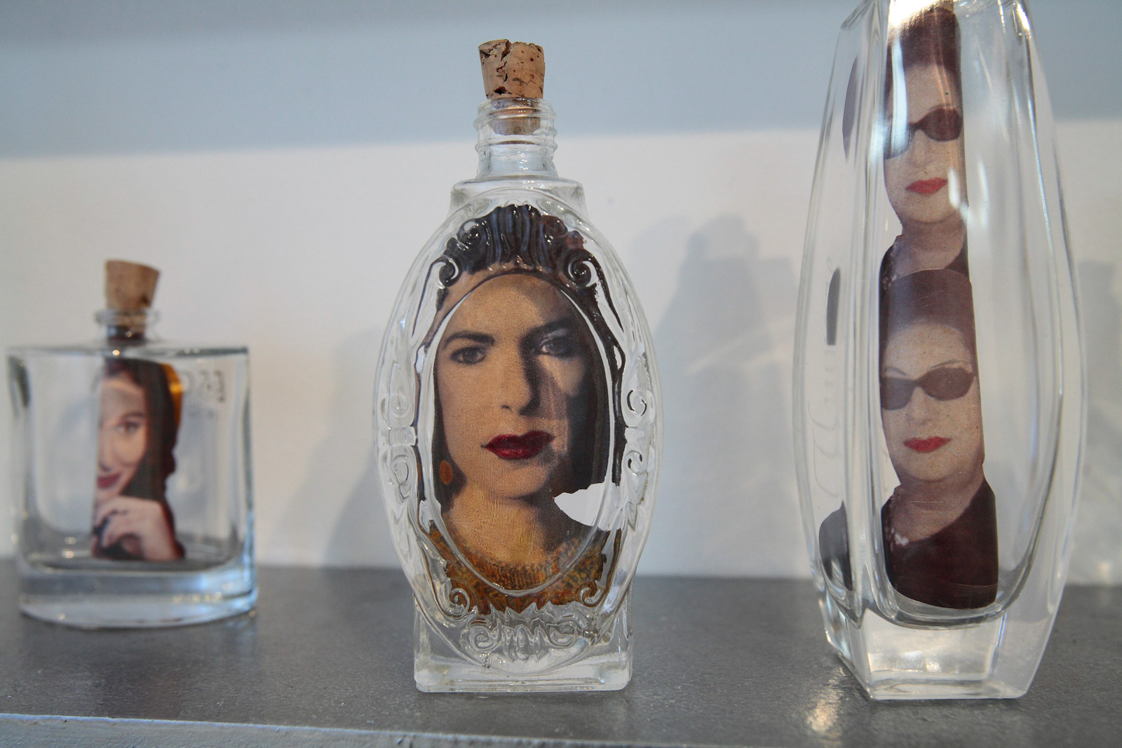 A perfume bottle with a label depicting a woman's face.