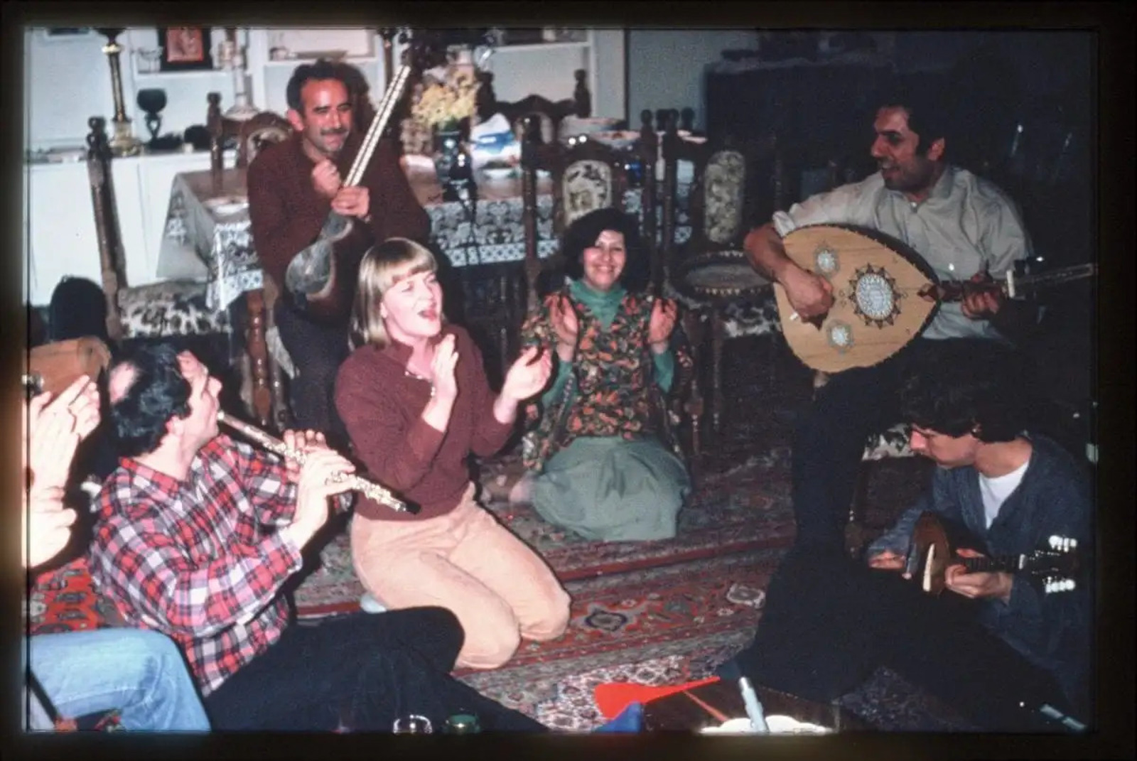 Musician George Totari plays the oud with his band members in an intimate  show at home, in a photo taken from the 1970s.
