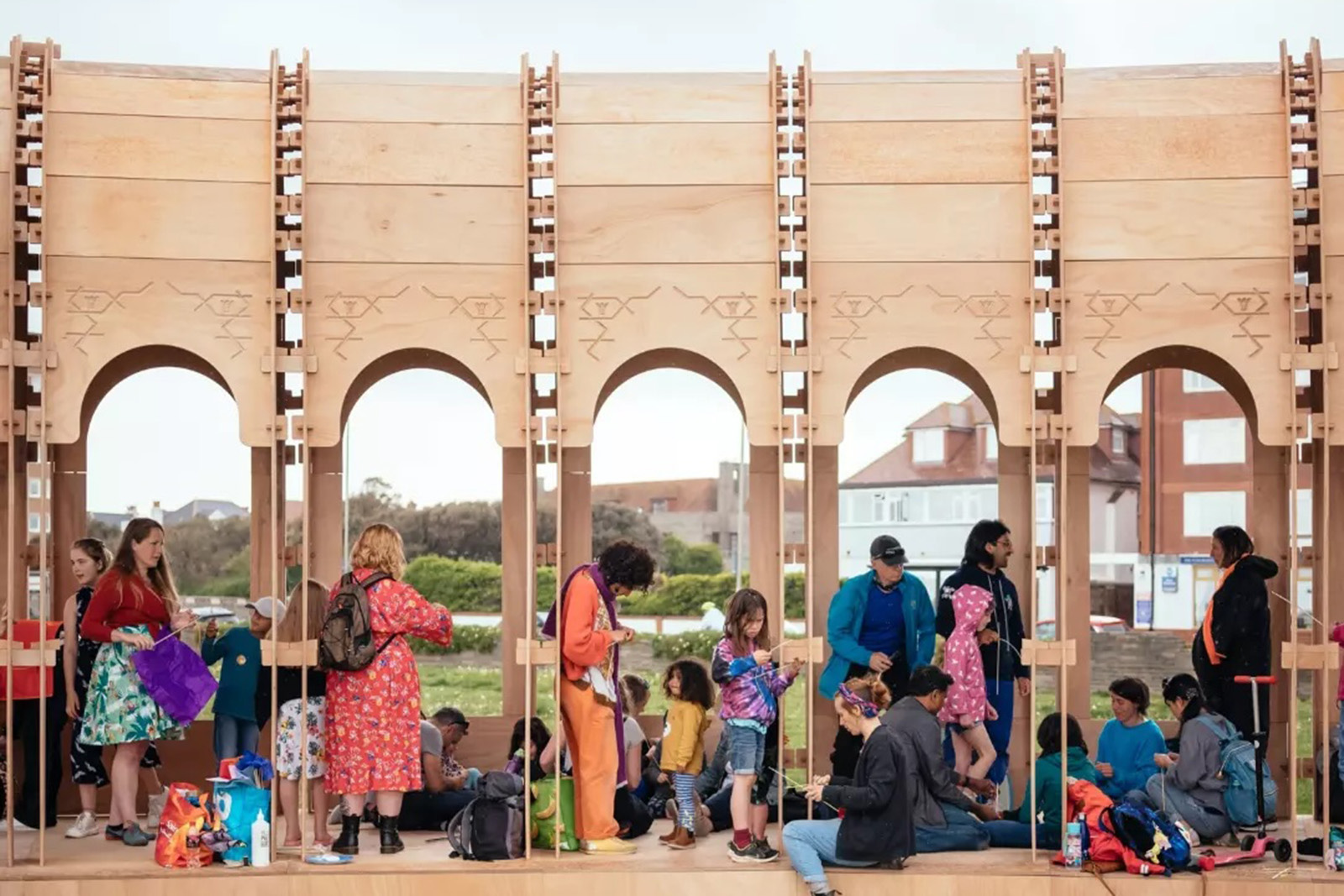 Families occupy an Arabic-style colonnade structure at the Brighton festival.