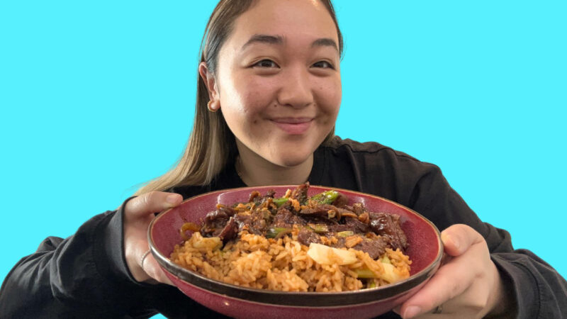 Michelle Lee holds up a dish containing beef stir-fry.