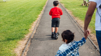 Two children in a park. Stock photo by SolStock/Getty Images
