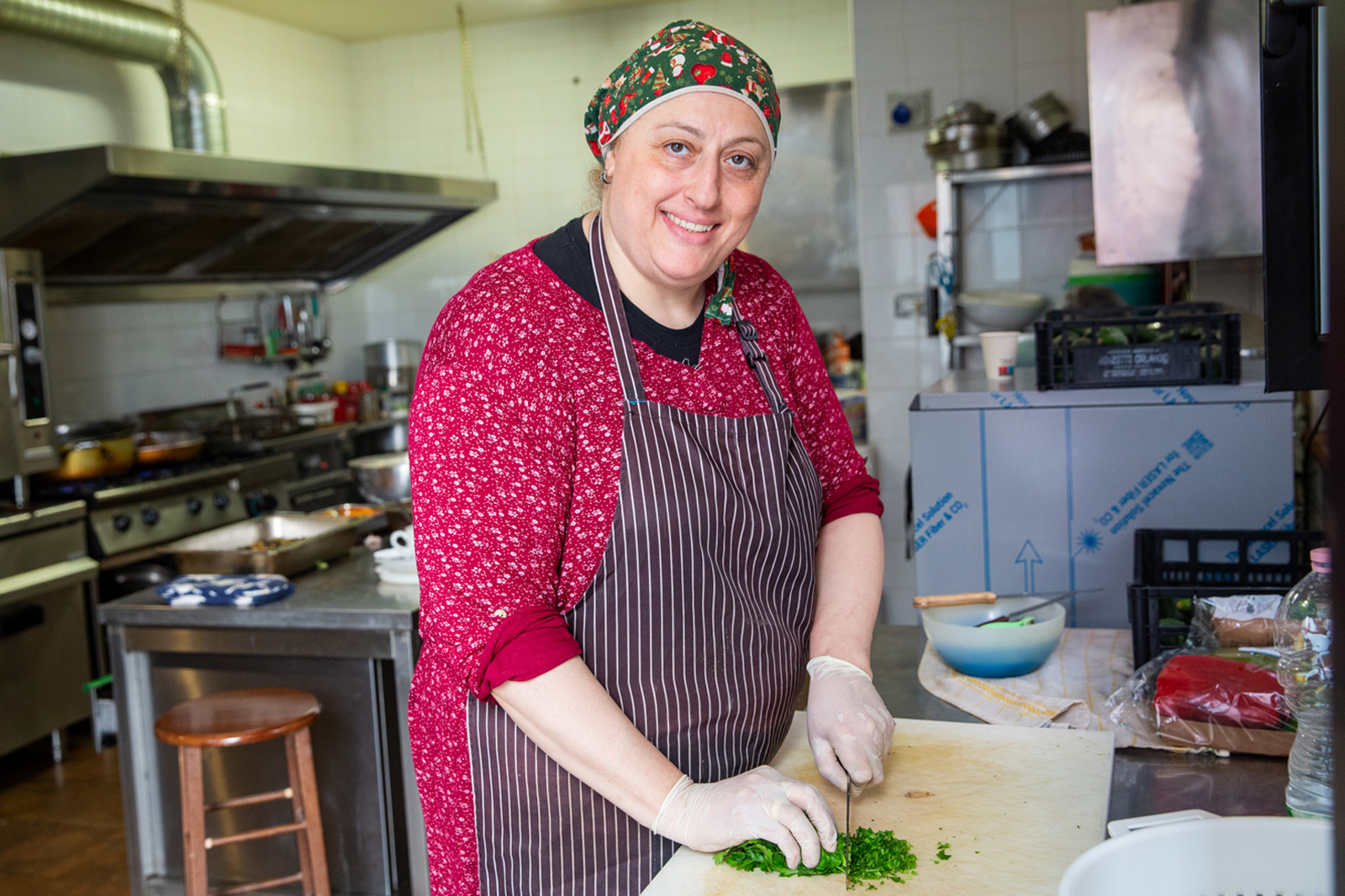 A chef poses for a photo in their kitchen. Photography for Hyphen by Francesca Leonardi