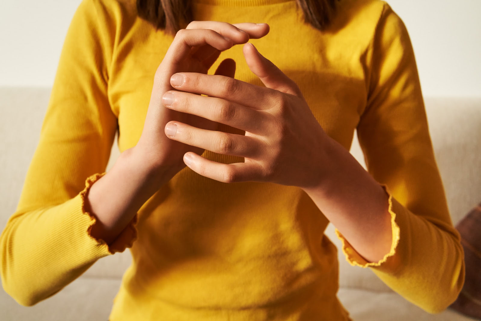 Young teenage girl top practising EFT or emotional freedom technique, tapping on side of the hand. Stock photo by Madeleine Steinbach/Getty Images