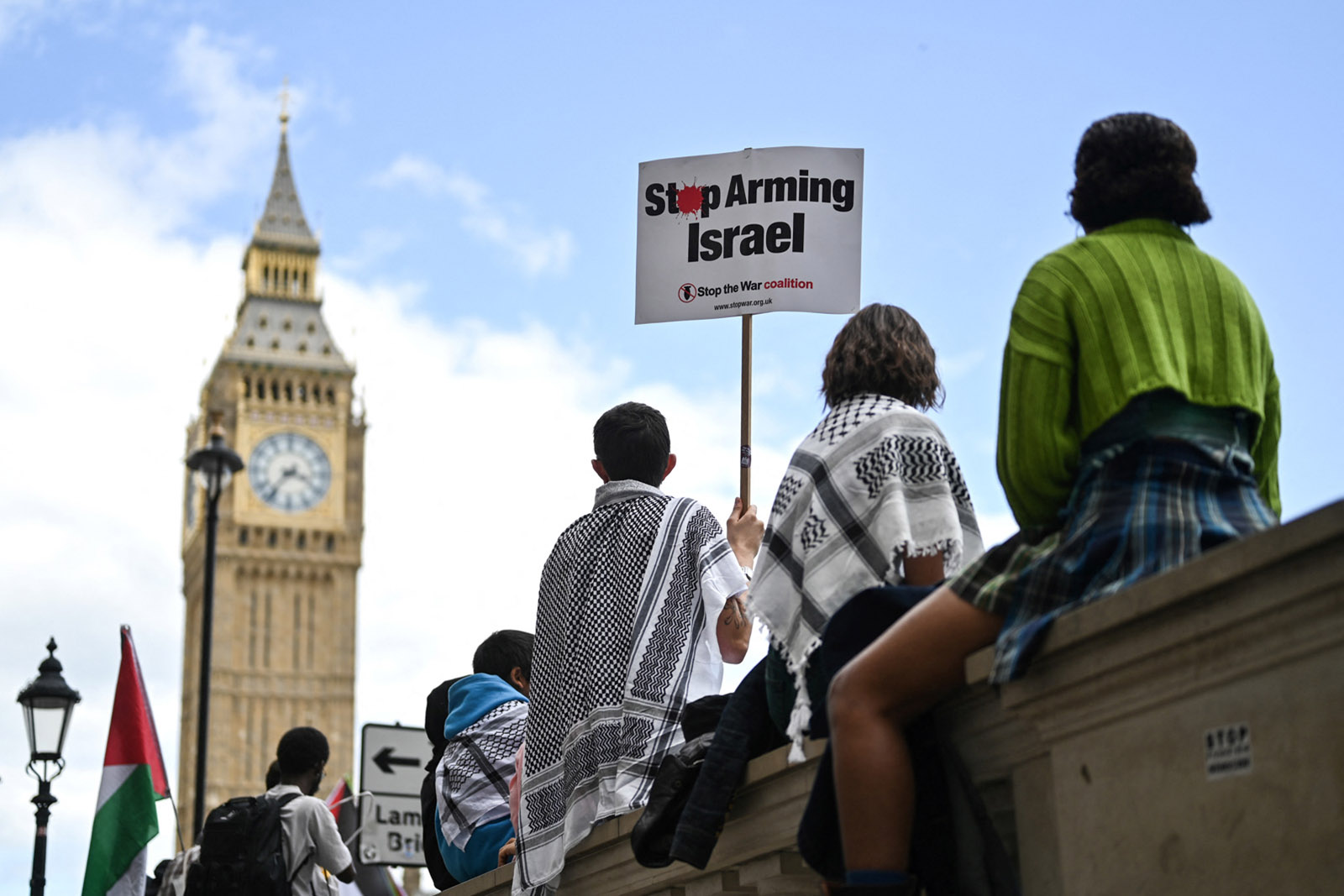 Protesters in front of Big Ben in London. One holds a sign saying 'Stop Arming Israel'. Protesters at a march for Gaza in London in June 2024. Photo by Justin Tallis via Getty Images