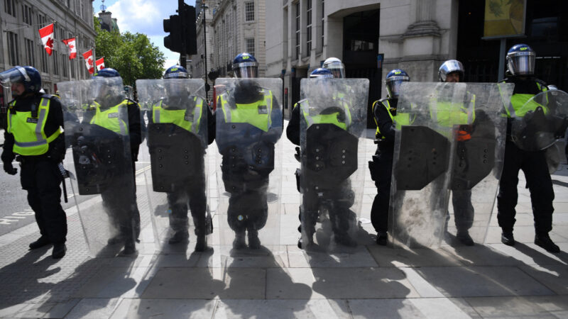 A line of riot police block the entrance to Whitehall at a Black Lives Matter protest action in central London on June 13, 2020, in the aftermath of the death of unarmed black man George Floyd in police custody in the US. - Police in London have urged people planning to attend anti-racism and counter protests on Saturday not to turn out, citing government regulations banning gatherings during the coronavirus pandemic. Photo by Daniel Leal / AFP