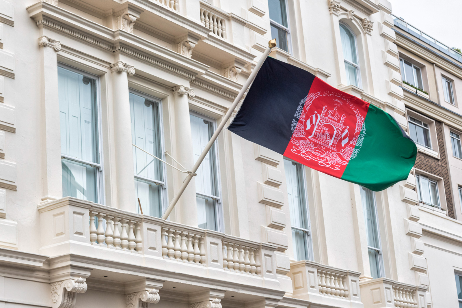 The Afghanistan flag flies outside the Afghan embassy in London, which is to close.