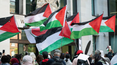 Palestinian flags fly as supporters of Marieha Hussain, 37, rally outside Westminster Magistrates' Court where she faces a racially aggravated public order charge for holding a placard depicting then PM Rishi Sunak and ex-Home Secretary Suella Braverman as coconuts during a pro-Palestine protest against Israel's war on Gaza.