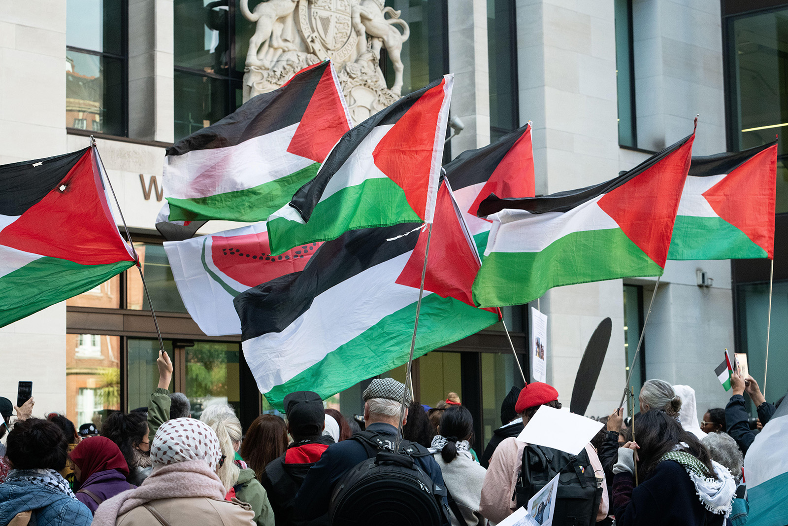 Palestinian flags fly as supporters of Marieha Hussain, 37, gather outside Westminster Crown Court. She is accused of racially aggravated public order after holding a placard depicting then-Prime Minister Rishi Sunak and former Home Secretary Suella Braverman as coconuts during a pro-Palestinian protest against Israel's war in Gaza.