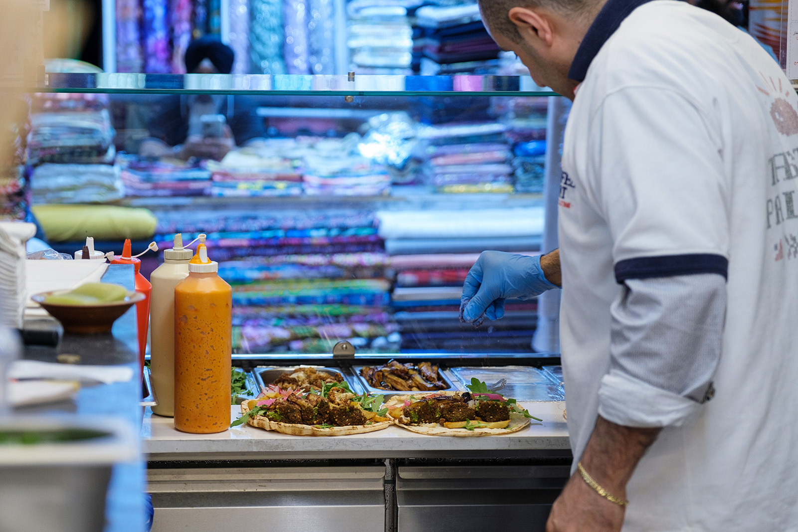 Hazaa, chef at Falafel Point, prepares a falafel wrap