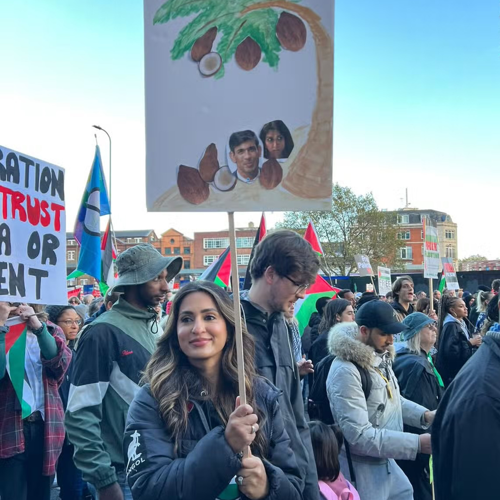 Protestor Marieha Hussain with a placard calling Rishi Sunak and Suella Braverman 'coconuts' at a pro-Palestine rally in London on 11 November 2023