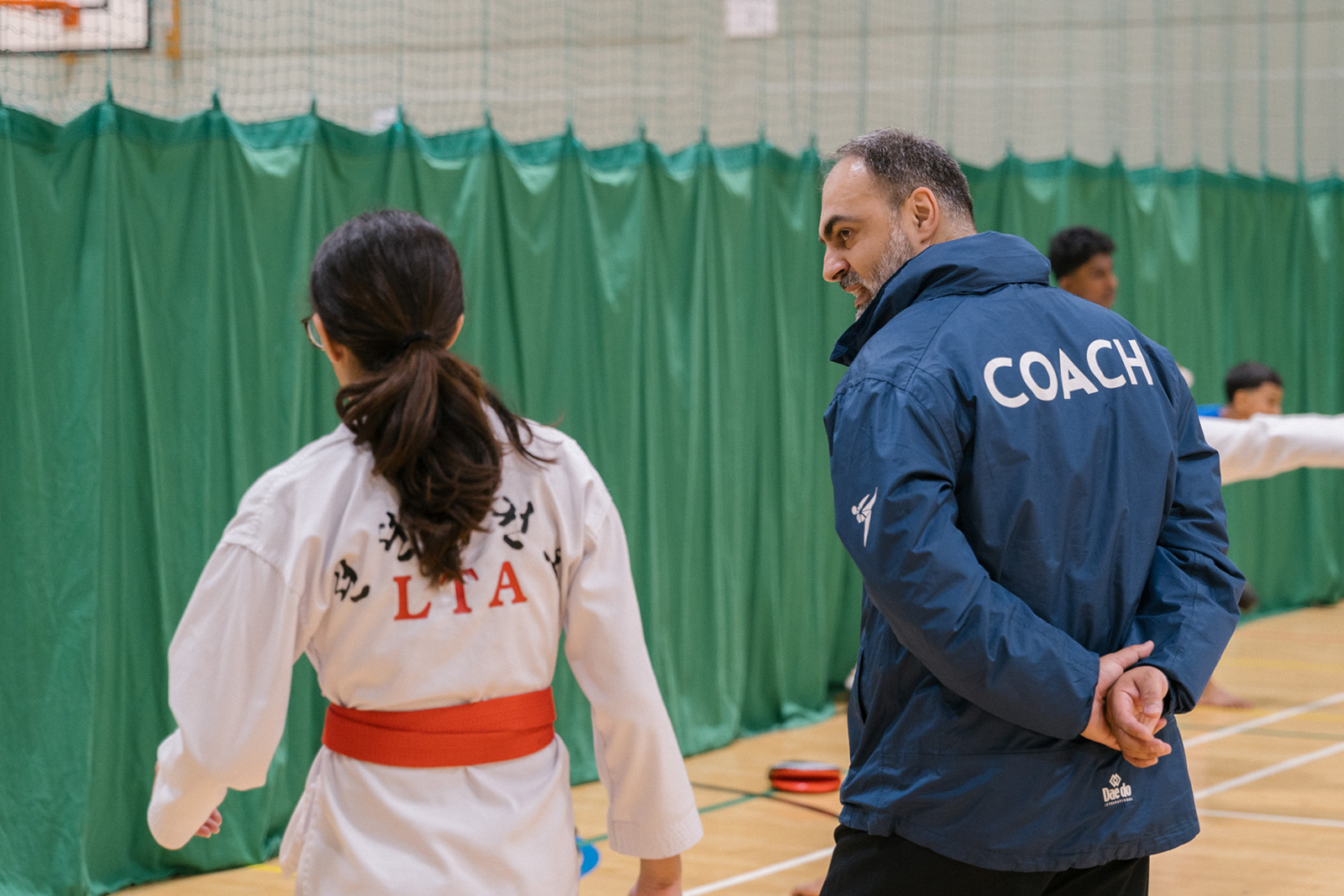 Coach Said Khelwatty of the London Taekwondo Academy talks to a student