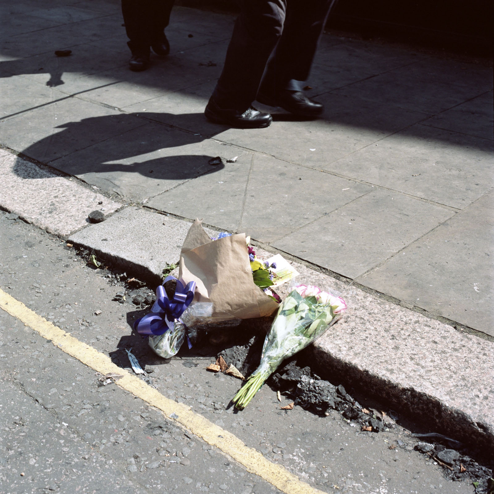 Police officers rushed down Latimer Road to assist residents. Already, flowers were being laid on the roadside in the ash that fell from the tower. Photography by Nicola Muirhead