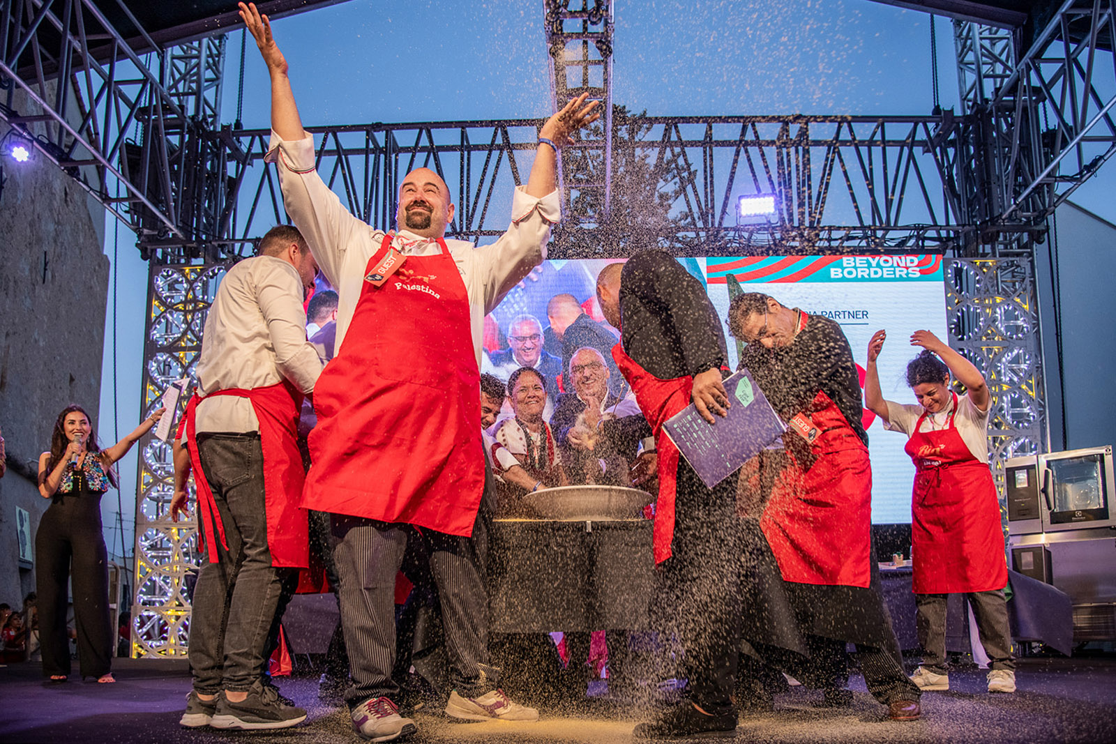 Chefs signal the opening of Sicily's annual Cous Cous Fest by tossing grains into the air like confetti. 