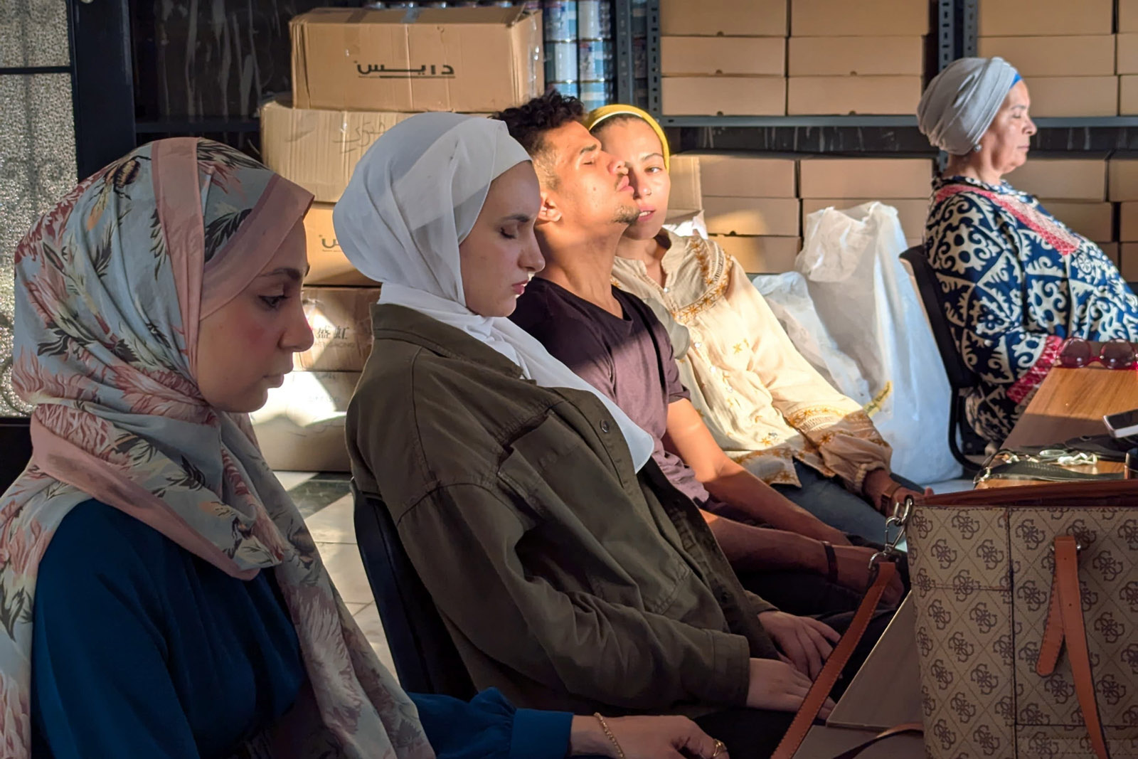 A row of Muslim women sitting in training at PalPsyche Line, which provides therapy to Gazan refugees in Egypt, Cairo.