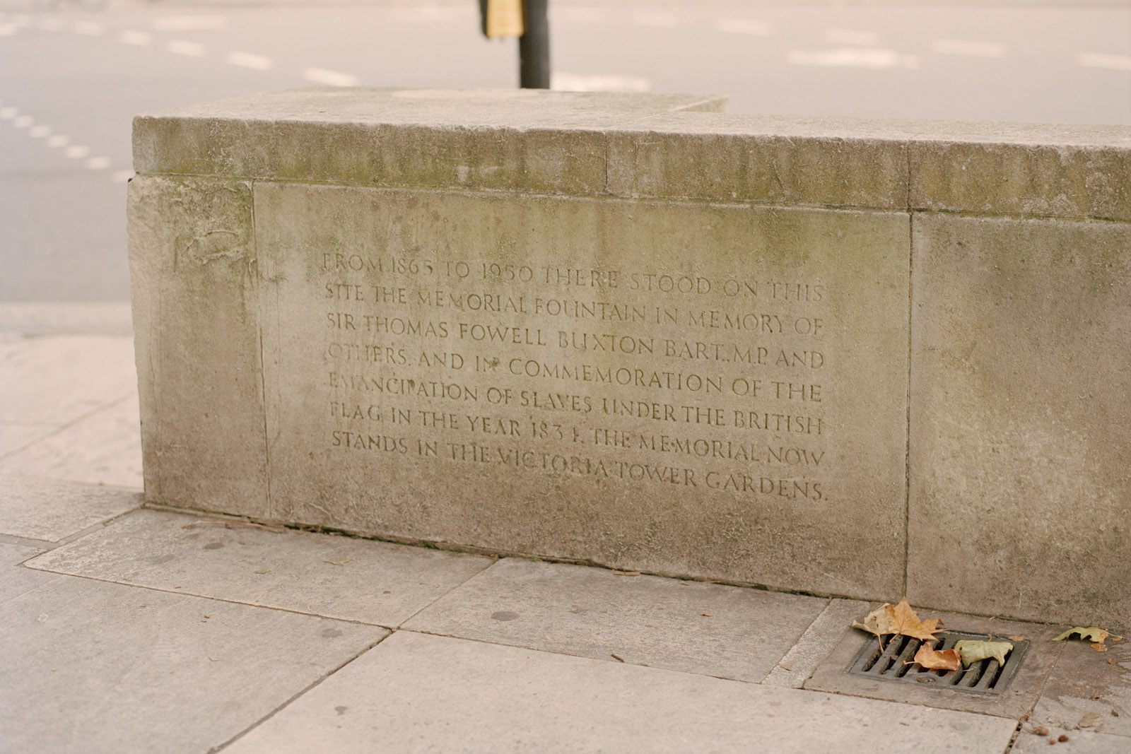 A stone in Parliament Square alluding to the Buxton Memorial which was moved to Victoria Tower Gardens. The memorial fountain commemorates the emancipation of slaves under the British flag in 1831.