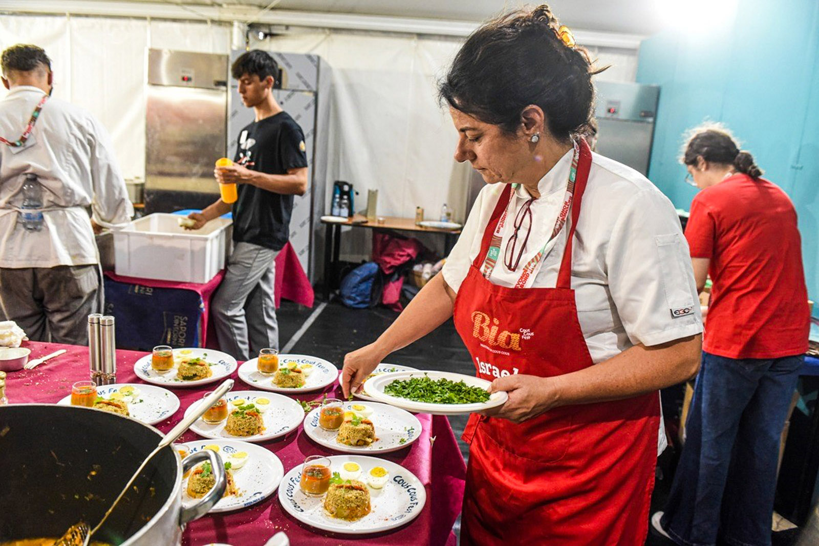 Israeli chef Tze’ela Rubinstein plates her dish at Cous Cous Fest 2024 in Sicily