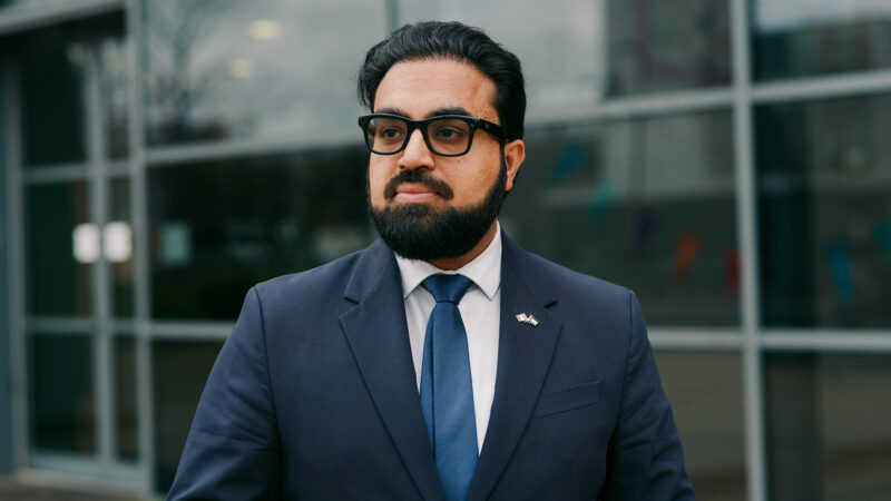 Dr Umar Al-Qadri, an independent candidate for Dublin North in the general election. Umar is photographed outside the Blanchardstown Library in Dublin. Umar stands outside the library, looking away from camera.