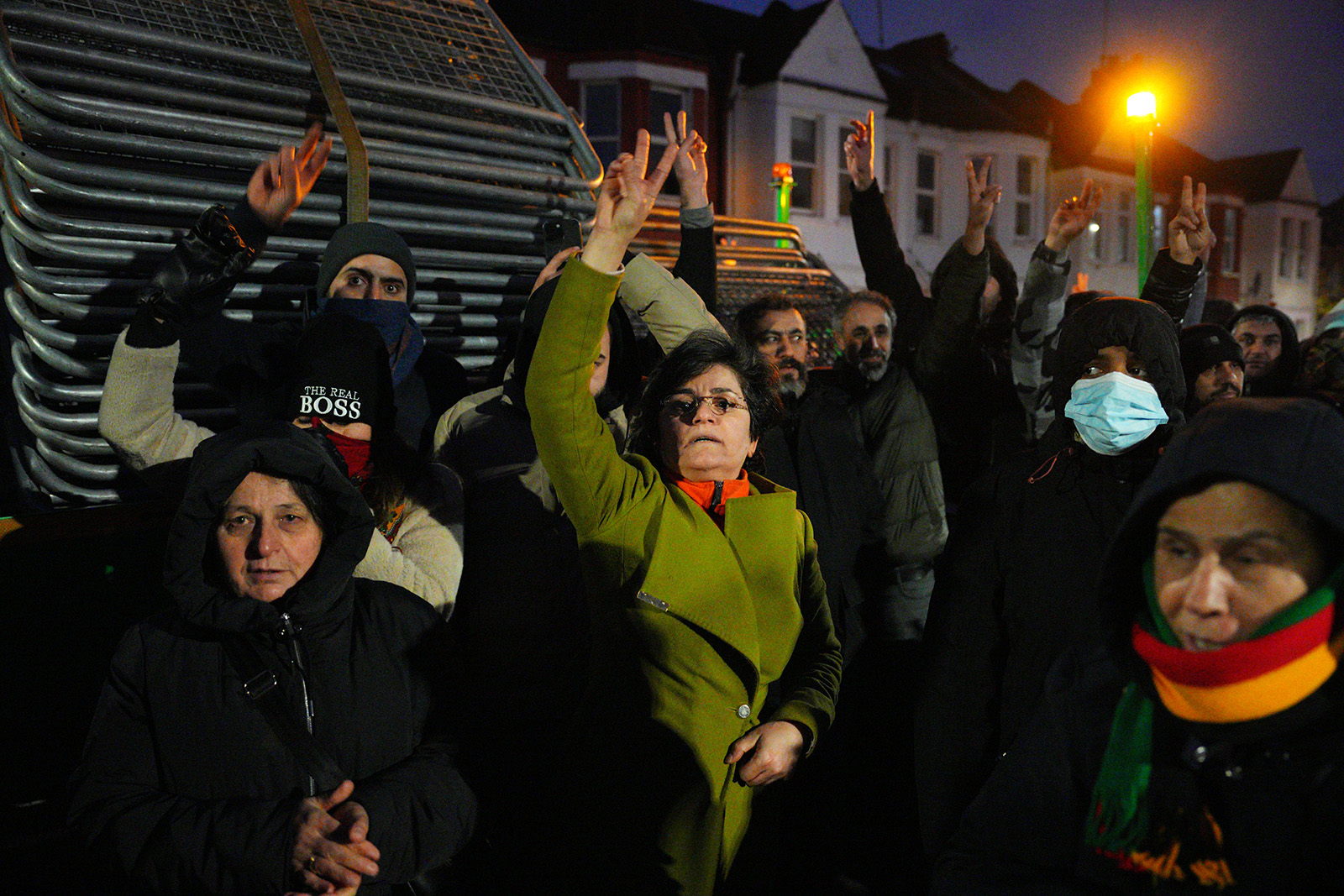 Kurdish people shout as they block barriers from being unloaded and used to stop access to a road leading to a Kurdish community centre that was raided by counter-terror police on November 27, 2024 in the London borough of Haringey, England. The Kurdish Community Centre was one of eight addresses raided by London Metropolitan Police this morning, leading to the arrest of six people. An official with the Met's Counter Terrorism Command said the raids followed an investigation into activities allegedly linked to the banned Kurdistan Workers' party, known as the PKK.