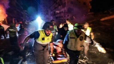 First responders evacuate an injured person following an Israeli airstrike that targeted the industrial zone in the southern Lebanese village of Abbasiyeh near Tyre on October 30, 2024