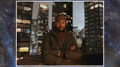 Muslim astronomer Hamza Ilyas in front of a cityscape at night