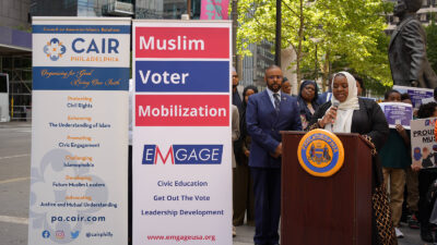 Salima Suswell (speaking) and Curtis Jones (to Salima's left) at Muslim City Hall Day in Philadelphia, June 2023