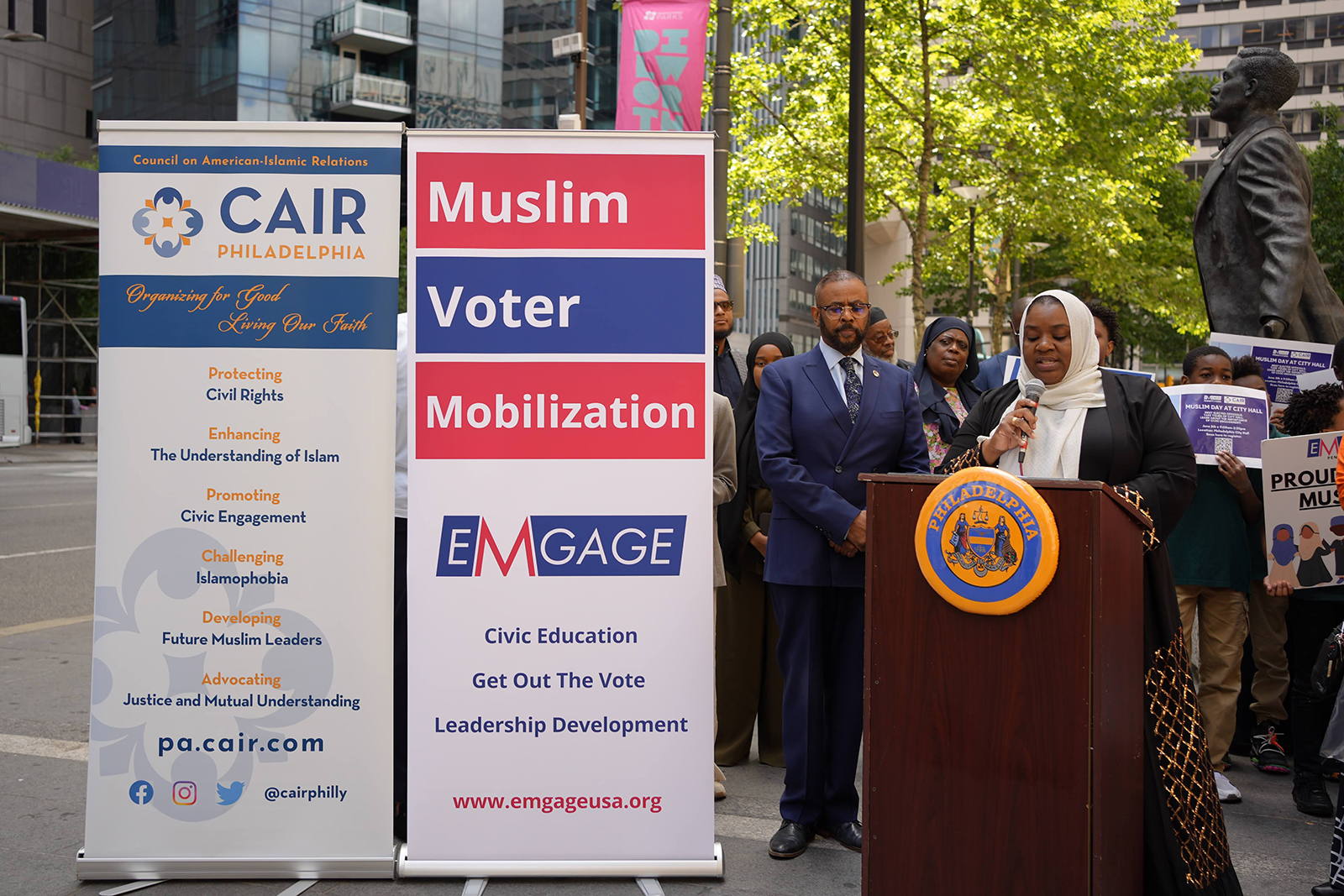 Salima Suswell (speaking) and Curtis Jones (to Salima's left) at Muslim City Hall Day in Philadelphia, June 2023