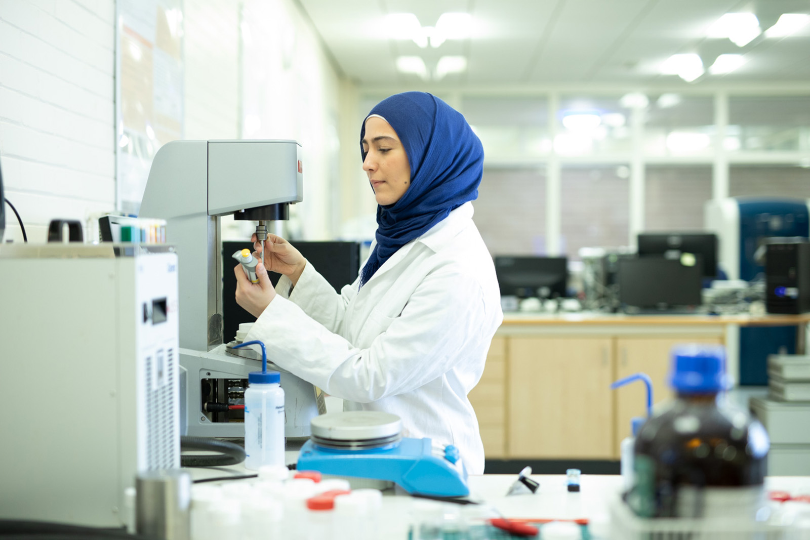 Gel expert Bana Shriky wearing a white coat in her laboratory