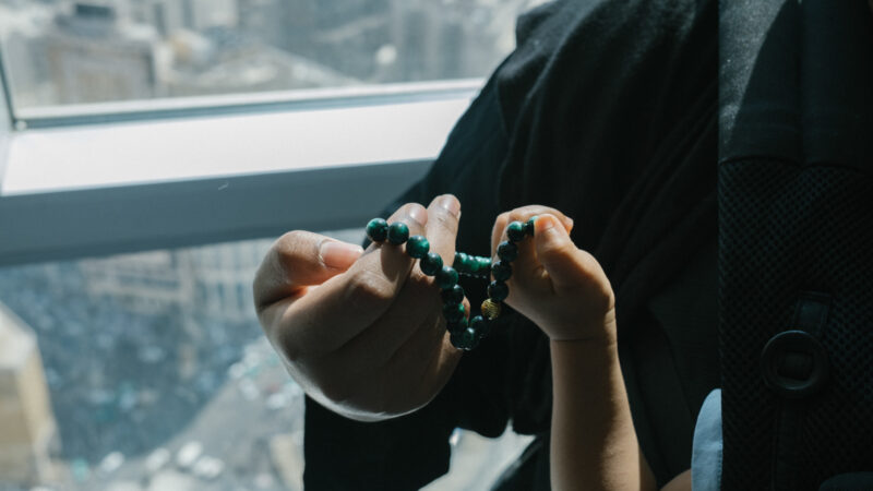 Amaal Said holding prayer beads with her son in Mecca.
