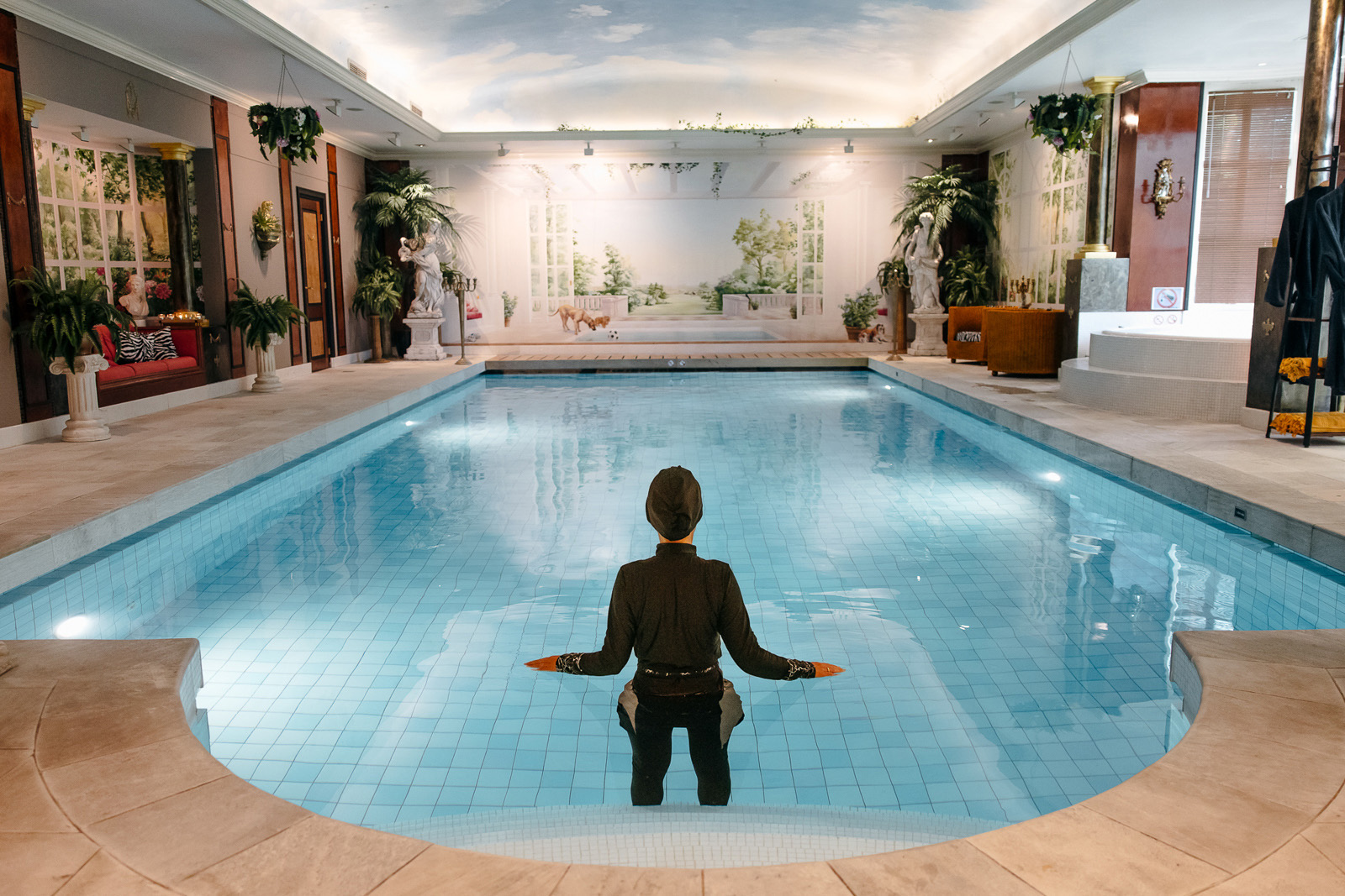 A woman wearing a black Burkina enters an underground swimming pool at Nardinclant spa in the Netherlands