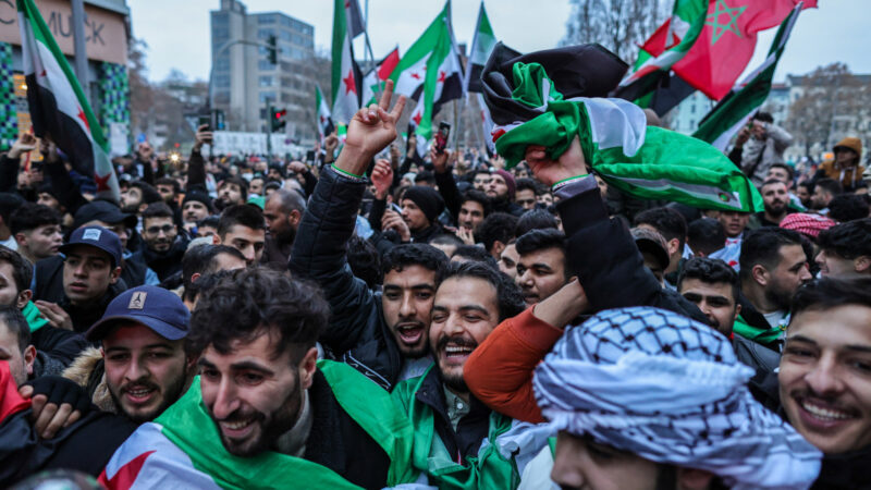 Expatriate Syrians gather with flags to celebrate the fall of the Assad regime in Syria on 8 December 2024 in Berlin.