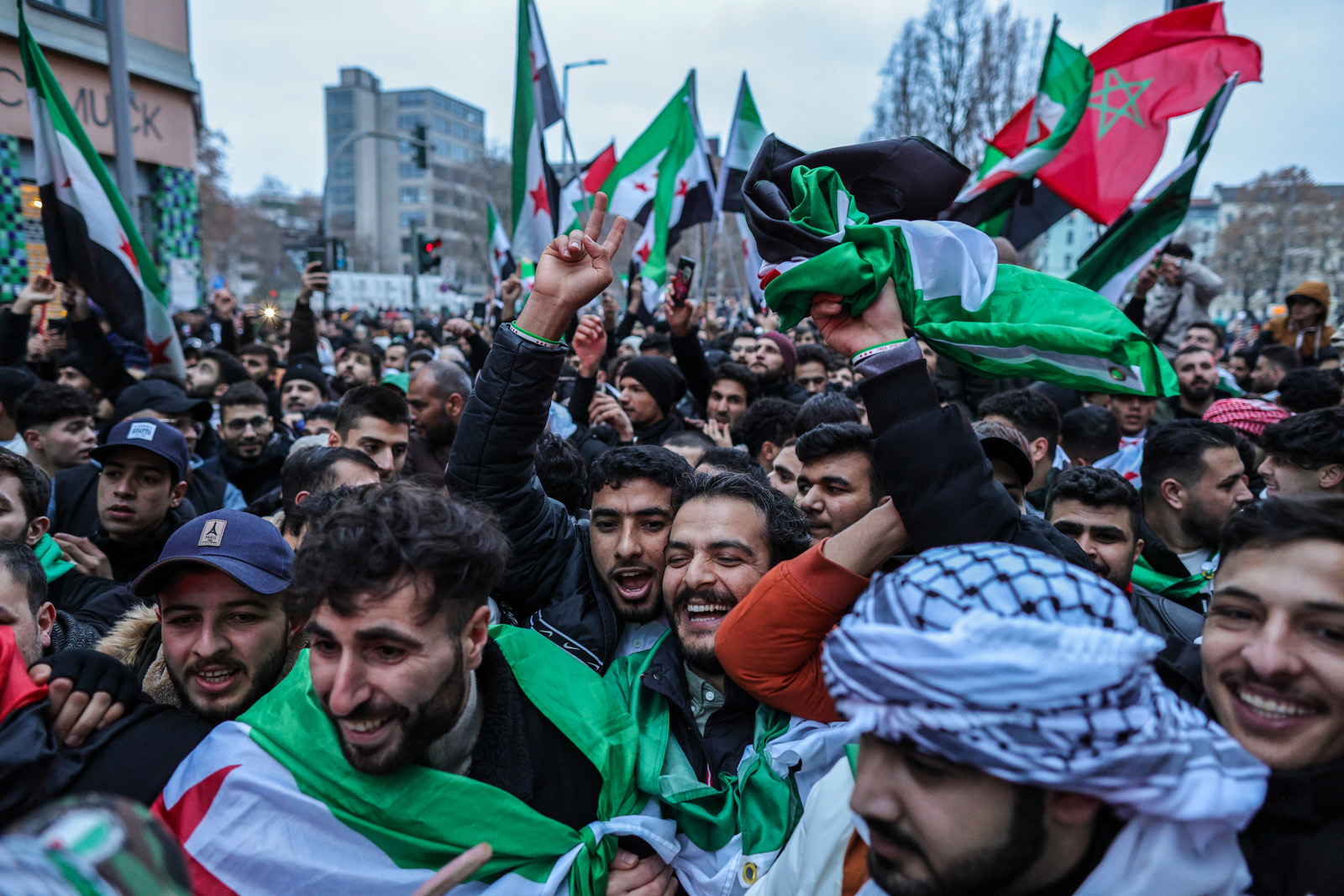 Expatriate Syrians gather with flags to celebrate the fall of the Assad regime in Syria on 8 December 2024 in Berlin.