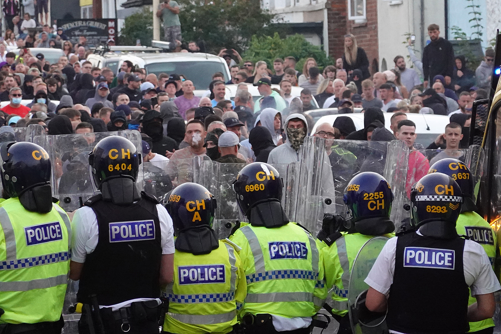 Riot police holding back protesters after disorder broke out in Southport on 30 July 2024.