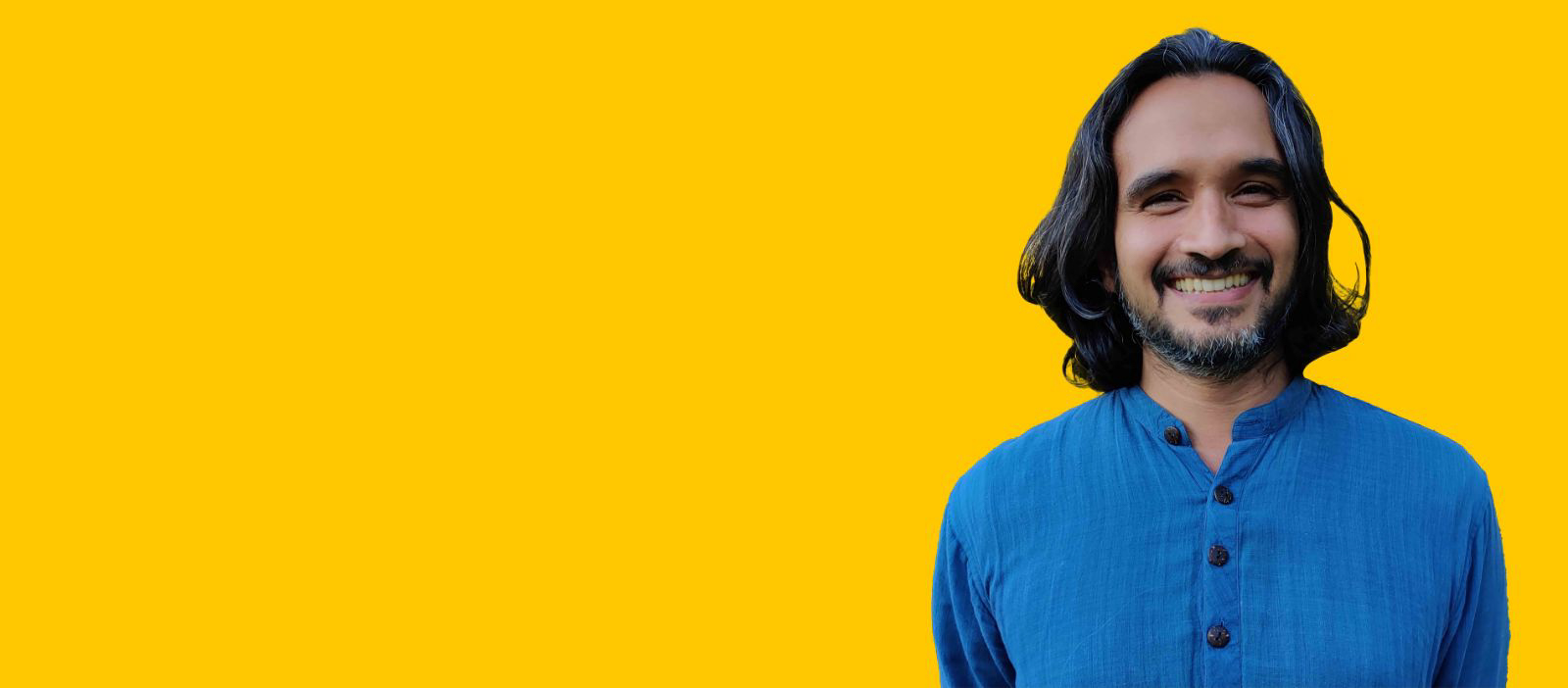 Murad Khan Mumtaz in a blue shirt against a yellow background