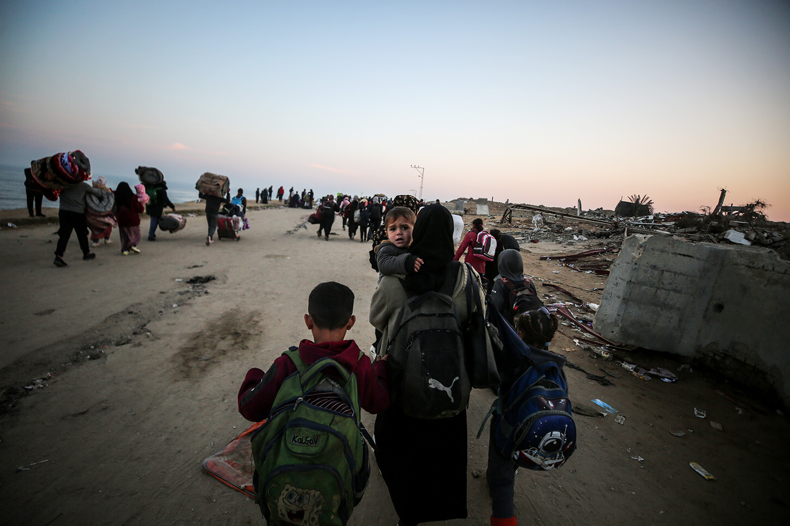 Displaced Palestinians making their way back on foot from the southern regions to their homes in the north via Al Rashid Road after the ceasefire agreement in Gaza Strip on January 28, 2025. 