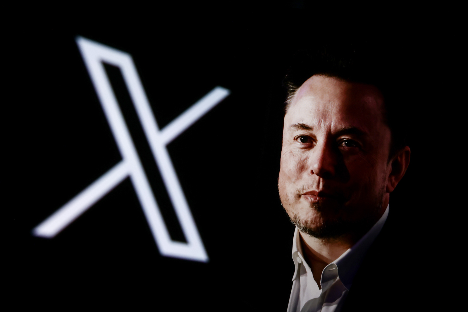 A portrait picture of Elon Musk photographed in Krakow, Poland on January 22nd, 2024 and X, former Twitter, logo are screened for illustration photo in Krakow, Poland on October 25, 2024. 