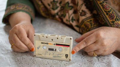 A woman's hands holding a cassette tape