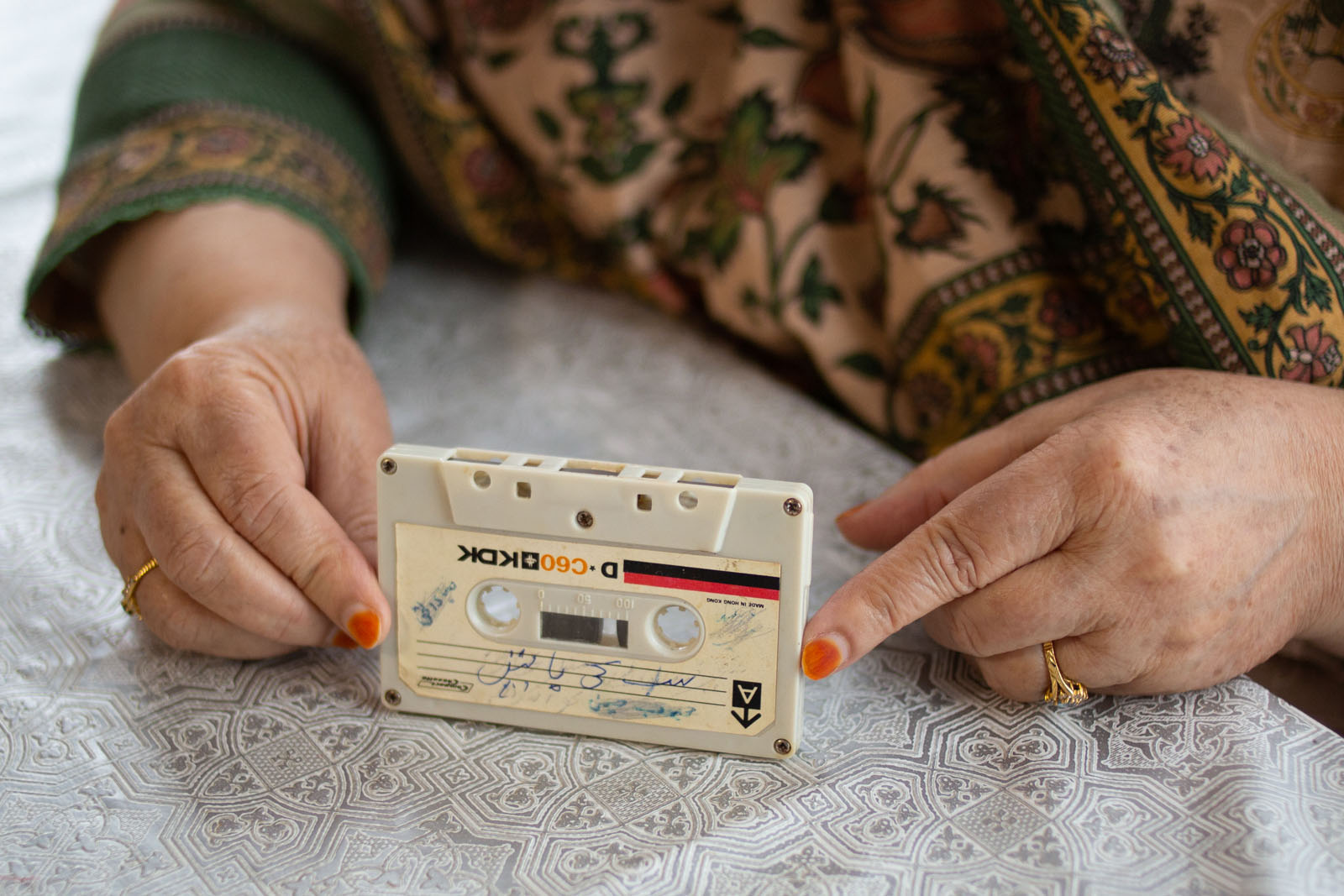 A woman's hands holding a cassette tape