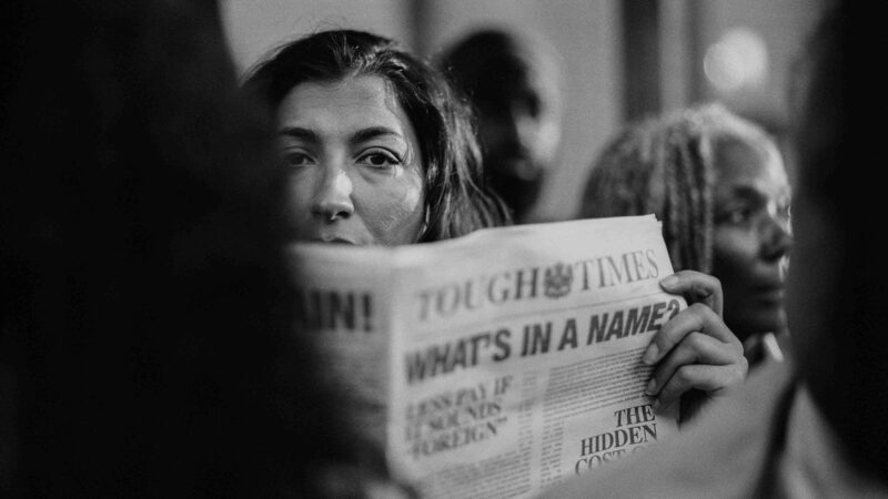 Yasmin Ali reading a newspaper