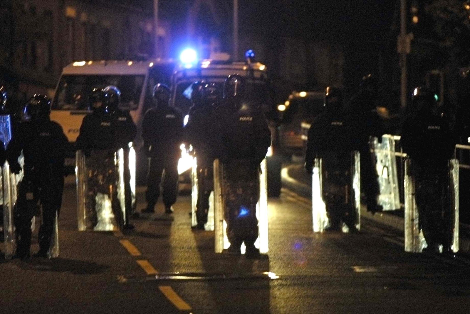 OLDHAM, UNITED KINGDOM: Police in riot gear blocks the road to keep members of the white and Asian community in the north English town of Oldham to clash 28 May 2001 as white protesters shouted anti Asian slogans during the third night of racial tension created clashes with the police.