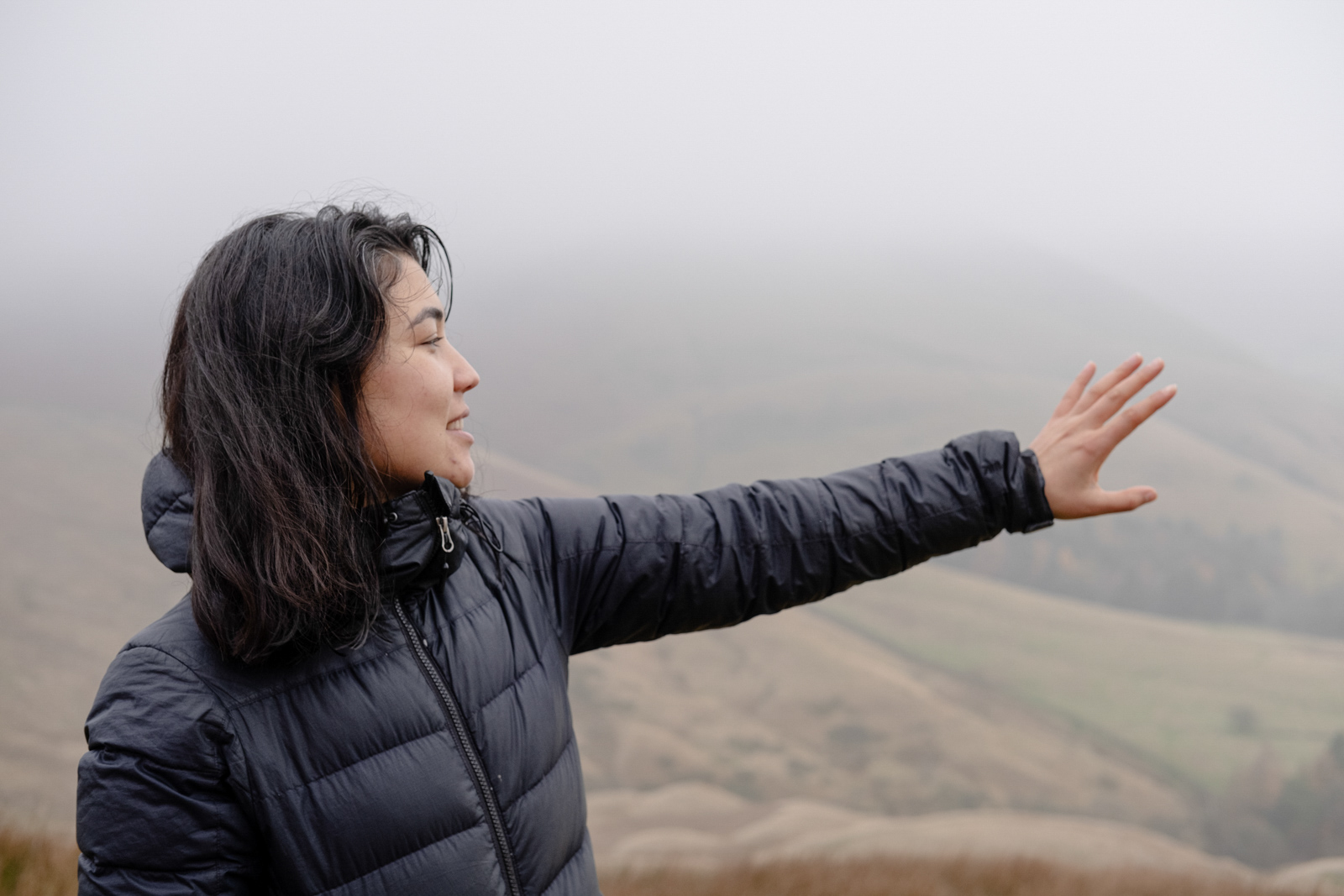 Freshta Ibrahimi looks over the landscape as we descend Mam Tor and come out of the heavy fog.