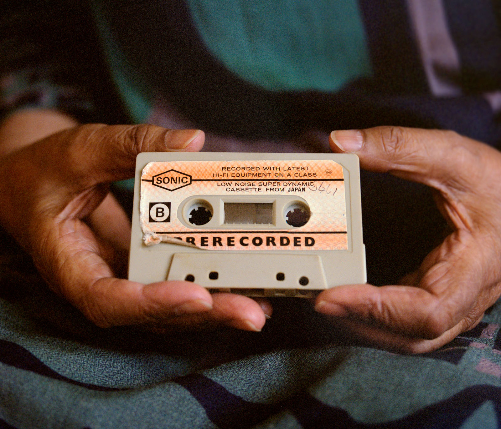 A woman's hands holding a cassette tape