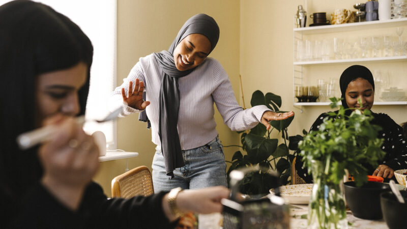 A group of young Muslim female friends joking around
