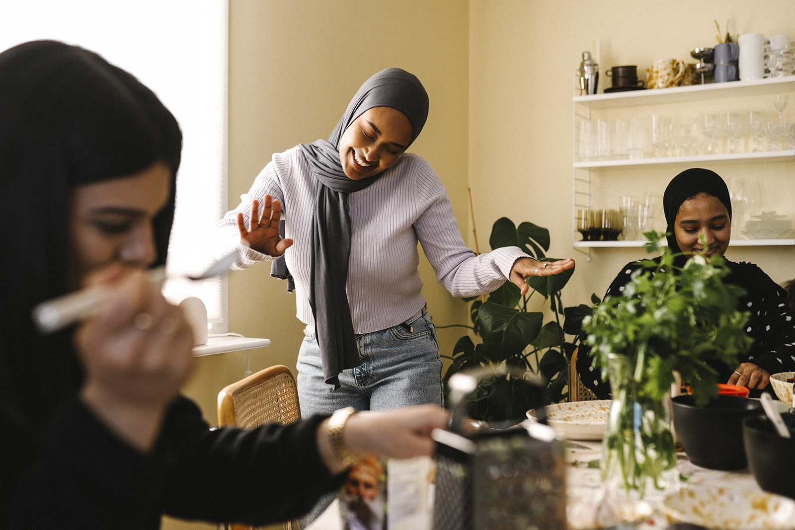 A group of young Muslim female friends joking around