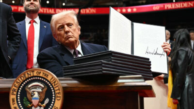 US president Donald Trump holds an executive order he just signed during the inaugural parade inside Capital One Arena, in Washington DC, on 20 January 2025.